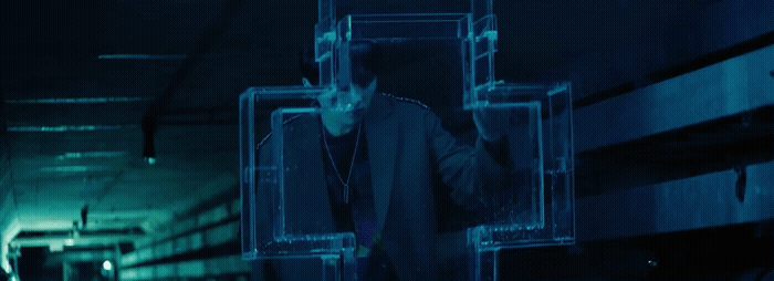a man in a suit and tie walking down a hallway