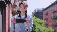 a woman holding a pink and black cell phone