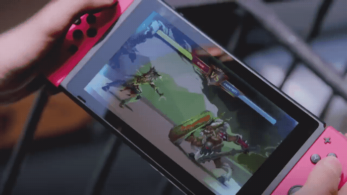 a person holding a pink nintendo wii game controller