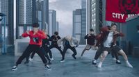 a group of young men dancing in a city