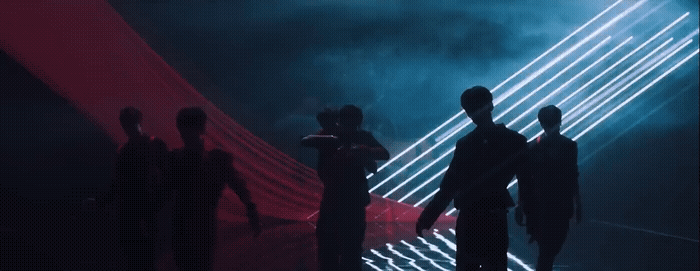 a group of people that are standing in the dark