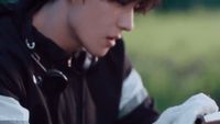 a young man is looking at his cell phone