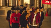 a group of young people standing in front of a building