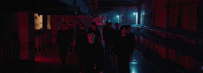 a group of people walking down a dark hallway