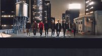 a group of young men walking across a city street