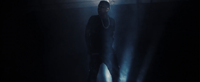 a man standing in a dark room with a flashlight