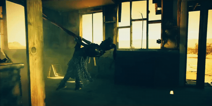 a woman is holding a sword in a dark room