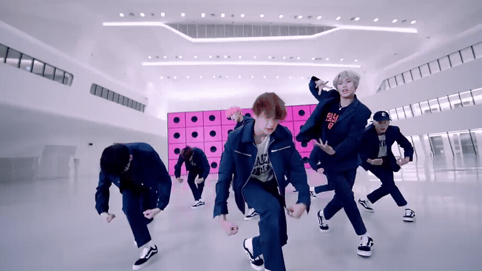 a group of young men dancing in a room