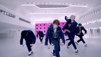 a group of young men dancing in a room
