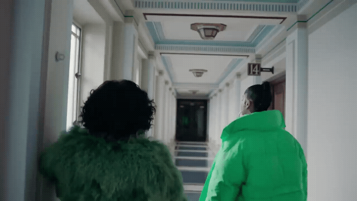 a man and a woman walking down a hallway