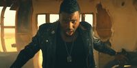 a man in a black shirt and a black jacket