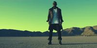 a man standing in the middle of a desert