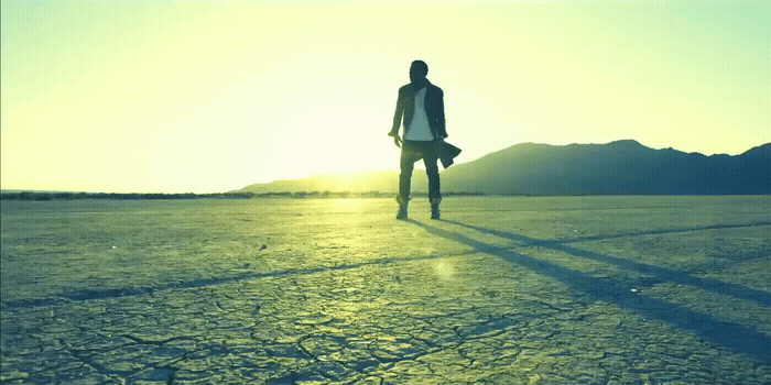 a man standing in the middle of a desert