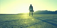 a man standing in the middle of a desert