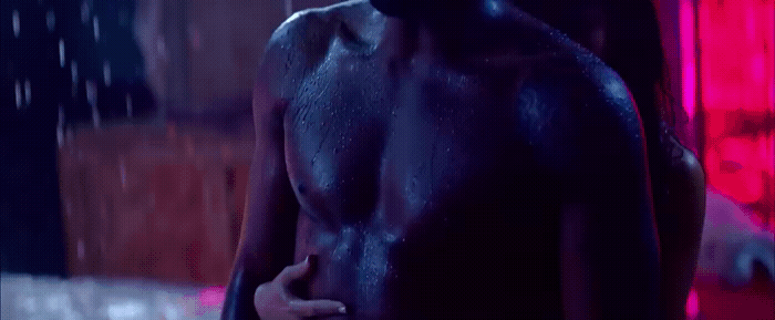 a man in a wet suit standing in the rain