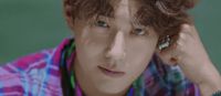 a close up of a person with curly hair