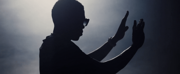 a silhouette of a man holding a cell phone
