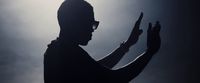 a silhouette of a man holding a cell phone