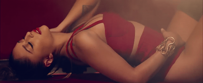 a woman in a red dress laying on the ground