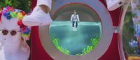 a person standing in front of a fake toilet