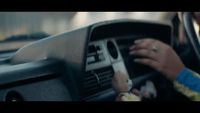 a close up of a person driving a car