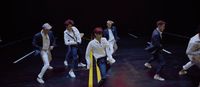a group of young men standing on top of a stage