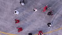 a group of people standing on top of a parking lot
