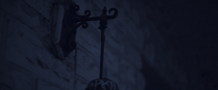 a street light on a brick wall in the dark