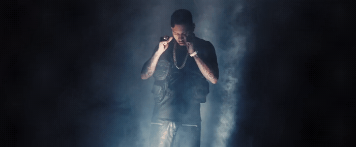 a male in a black shirt and some smoke