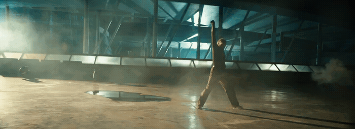 a person standing in a room with a light on