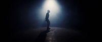 a person standing in a dark room with a light on