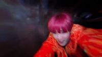 a person with pink hair and a red jacket