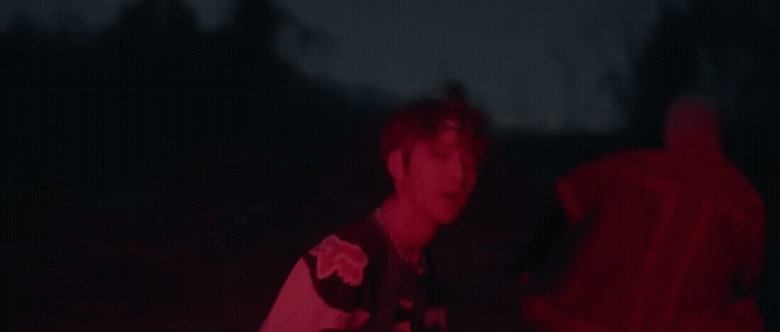 a man standing in the dark with a frisbee in his hand