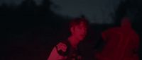 a man standing in the dark with a frisbee in his hand