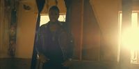 a man standing in a room next to a window