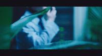 a blurry photo of a person holding a plant