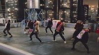 a group of people are dancing on a stage