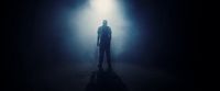 a person standing in a dark room with a light on