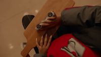 a person holding a remote control in their hand