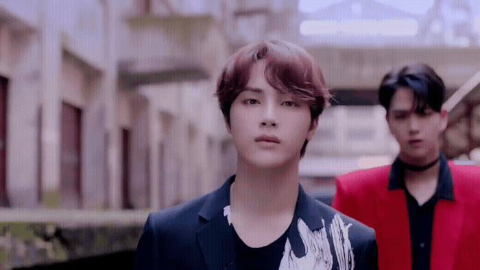 a couple of young men standing next to each other