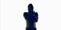 a silhouette of a woman covering her face with her hands