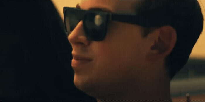 a man wearing sunglasses looking off into the distance