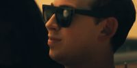 a man wearing sunglasses looking off into the distance
