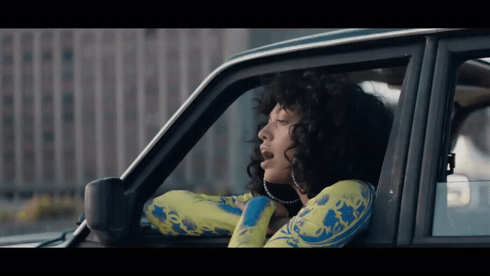 a woman sitting in the passenger seat of a car
