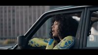 a woman sitting in the passenger seat of a car