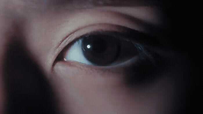 a close up of a person's eye with a blurry background