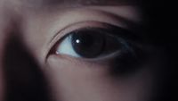 a close up of a person's eye with a blurry background