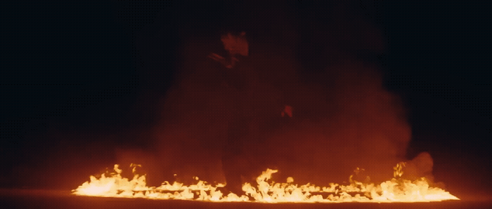 a man standing in front of a bunch of fire