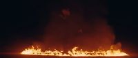 a man standing in front of a bunch of fire