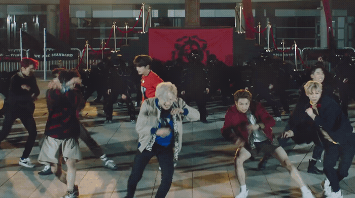 a group of people dancing on a tiled floor